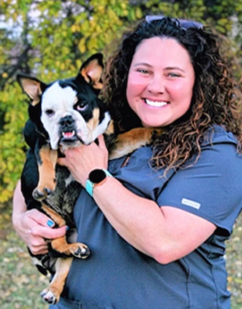 Misty Wilson R.V.T. Smiling while Holding a Dog